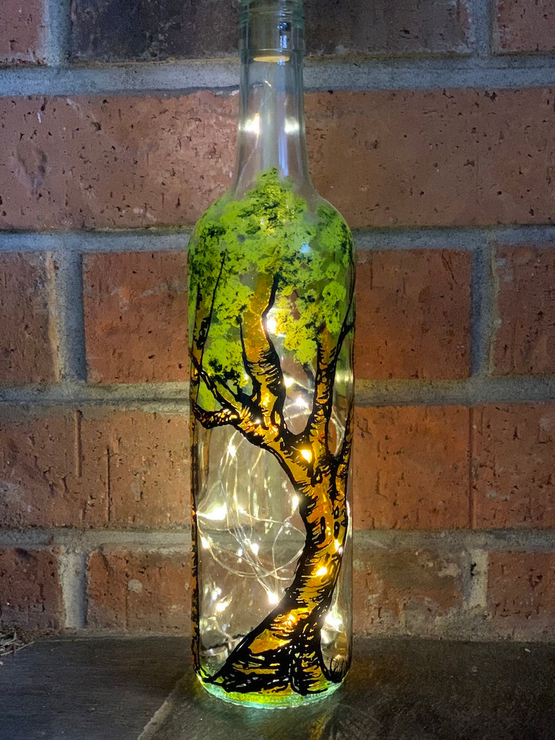 Hundred Acre Woods is inspired by Christopher Robin's forest that Winnie-the-Pooh lives in. Painted on a recycled bottle with acrylic paint. The bottle is lit with fairy lights from within.